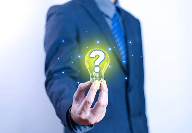 istock Innovation concept and inspiration. Businessman holding creative light bulb with question mark icon. Strategic planning. Modern business and inspiration. 2208435100