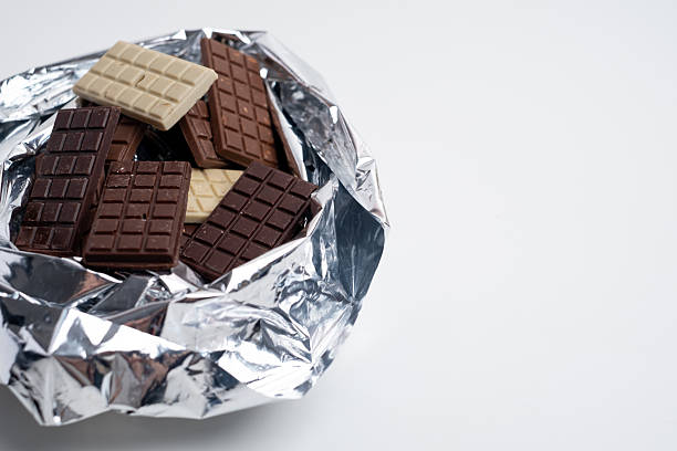 Multicolored chocolate bars placed on a light background. Healthy eating concept, delicious chocolate candies, diet, sugar