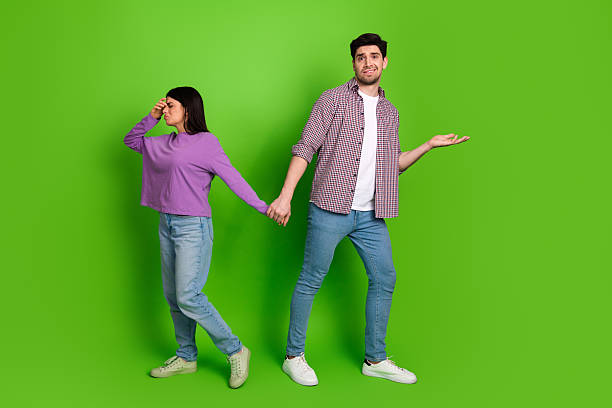 istock Young couple sharing mixed emotions on vibrant green background, exploring love, relationships 2208436577