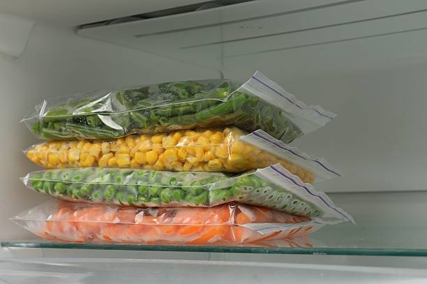 istock Plastic bags with different frozen vegetables in refrigerator, closeup 2208437182