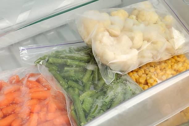 istock Plastic bags with different frozen vegetables in refrigerator, closeup 2208437187