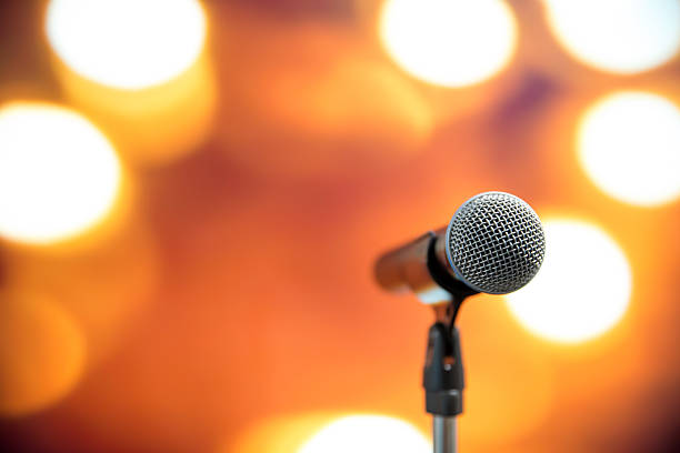 istock Microphone Public speaking background, Close-up the microphone on stand for speaker speech presentation stage performance with blur and bokeh light background. 2208438695