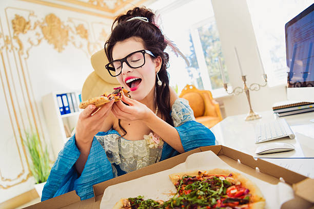 istock A Creative Woman in Vintage Attire Enjoying Pizza in a Modern Office Setting 2208438751