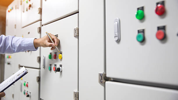 istock Electricity and electrical maintenance service, Engineer checking air handling unit AHU starter button control panel and hvac system of air conditioner load center cabinet for maintenance. 2208438889