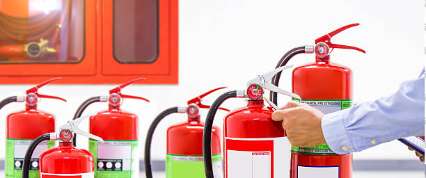 istock Fire extinguisher, Engineer inspection checking pressure gauge level fire extinguisher tank with fire hose cabinet of protection and prevent emergency and safety rescue and fire alarm system training. 2208439056