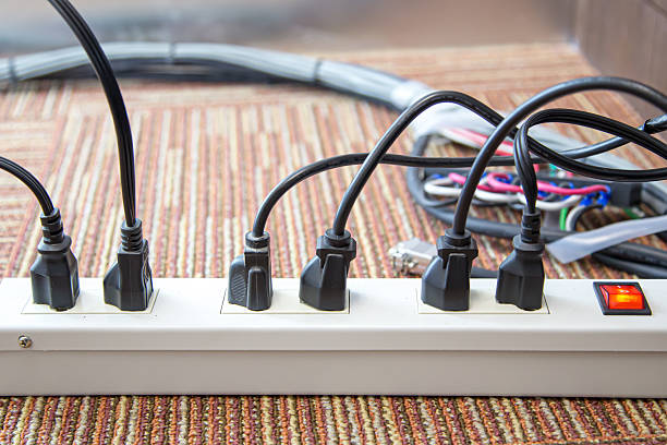 istock Old and damaged electric adapter power plug has many appliances are plugged outlet socket concept of risk danger overloaded current electrical. 2208439101