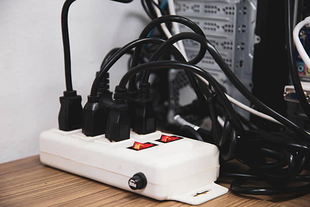 istock Old and damaged electric adapter power plug has many appliances are plugged outlet socket concept of risk danger overloaded current electrical. 2208439102