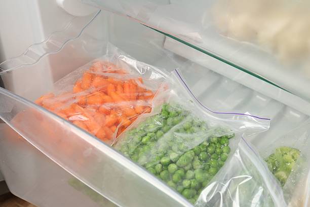 istock Plastic bags with different frozen vegetables in refrigerator, closeup 2208440172