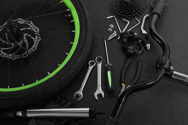 istock Parts of bicycle and tools on black background 2208440694