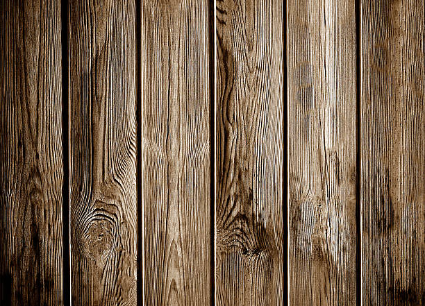 istock Old brown wooden planks showing knots and grain creating rustic background 2208440765