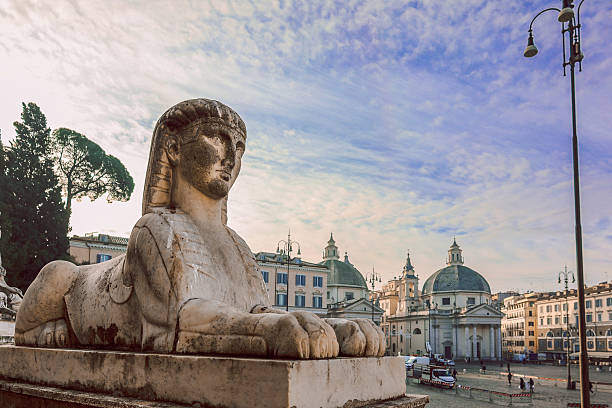 Sphinx statue in Piazza del Popolo square, Rome, Italy. In background twin churches, selective focus. High quality photo