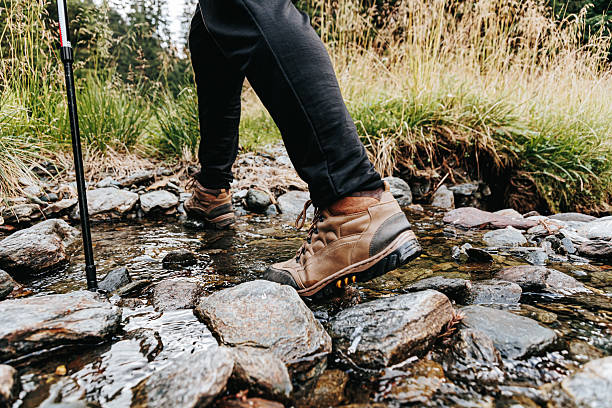 istock Hikers feet splash in mountain river during a nature adventure 2208446665