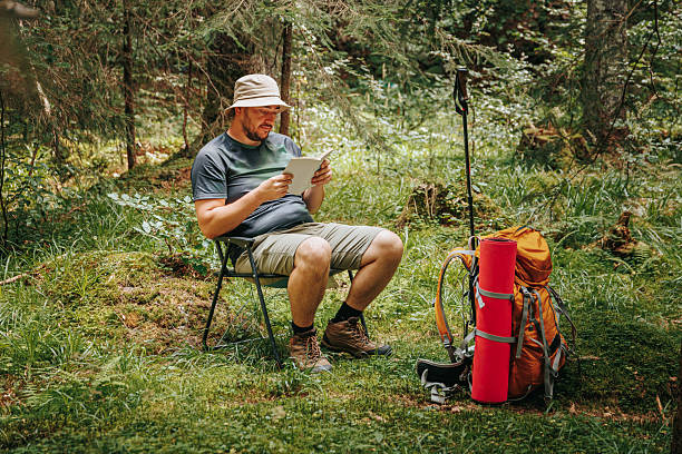 istock Hiker discovers peace in nature while reading a book in the woods 2208446669