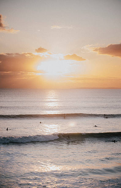 istock The sun is setting over the ocean, casting a warm glow on the water 2208446805