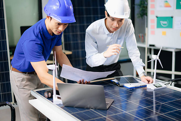 istock Two Asian engineers collaborate on solar and wind energy, driving clean innovation and sustainability. 2208447035