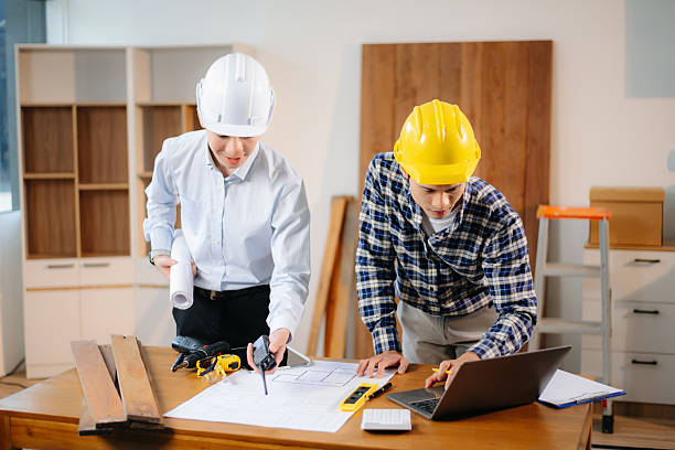 istock Engineer teams meeting working together wear worker helmets hardhat with on architectural project site and making model house. 2208447074