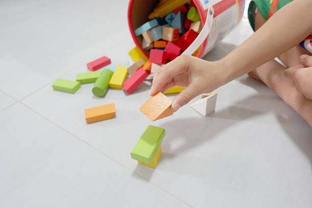 istock A boy's hands are playing with colorful wooden building blocks. 2208448647