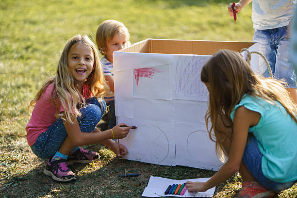 istock Children draw on a cardboard box in the park 2208449536