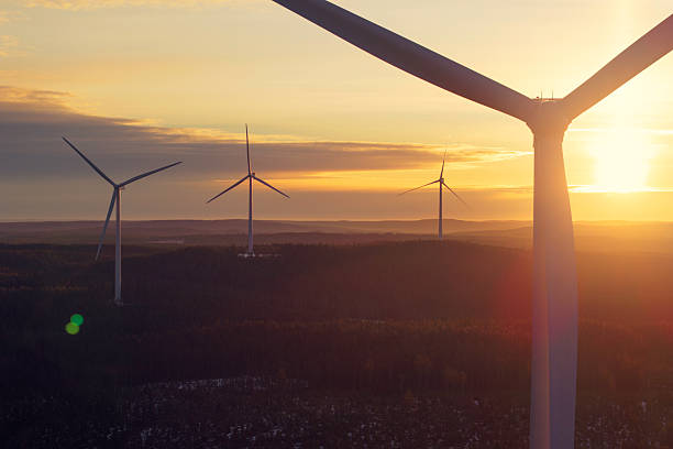 istock Sunrise in a landscape with wind turbines 2208450014