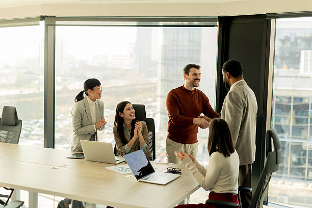 istock Team collaborates in modern office setting on innovative project with laptops and discussion 2208451113