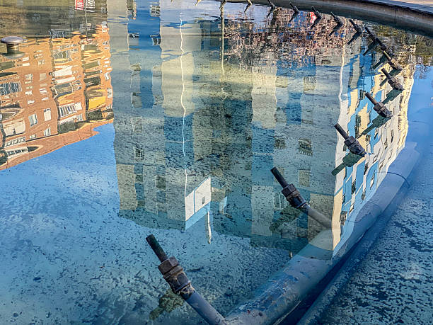 High angle close-up view of residential buildings reflected on water fountain in the city of Valencia, Spain