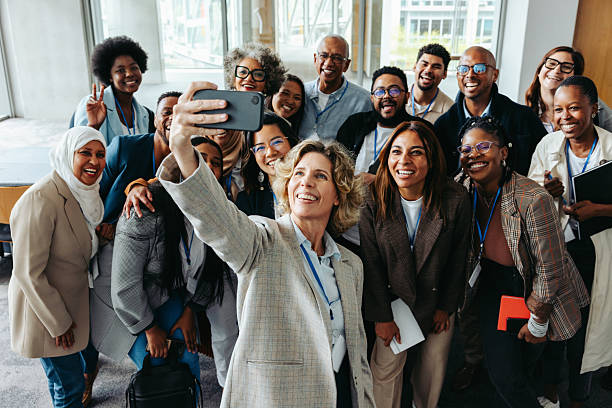istock Smiling colleagues taking a selfie at a corporate event for team bonding 2208453379