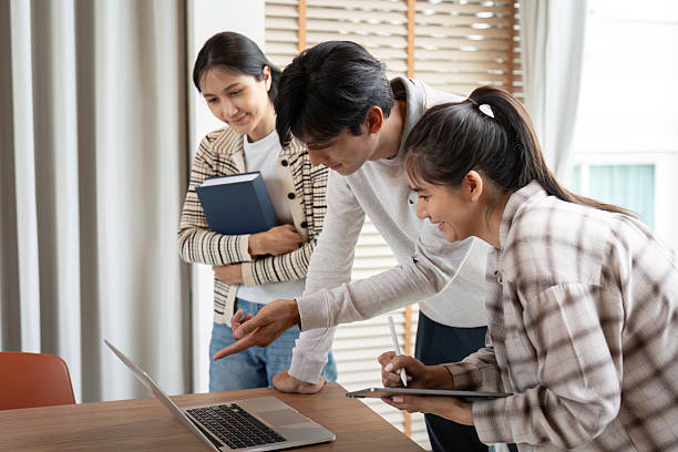 istock Collaboration and Discovery. Students excitedly engage over shared research findings on their laptop. 2208454694