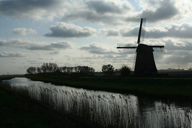 Schermerhorn,North-Holland,Netherlands,june 2017:Silhouette of  historical windmills in the landscape of the Schermer polder