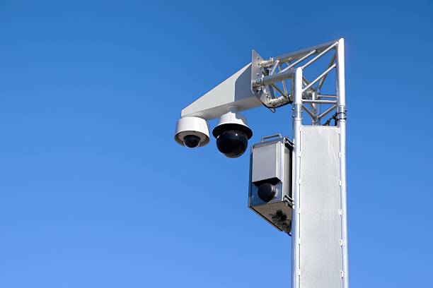 istock Surveillance cameras mounted on the pole with blue sky 2208455954
