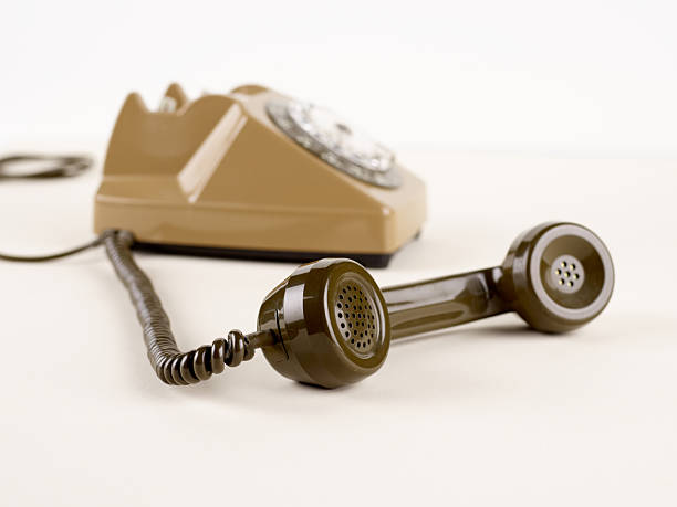 Numbers and letters for dialing are visible. Beige background.