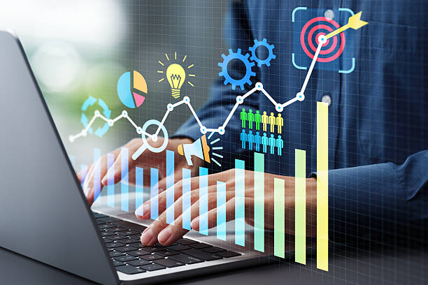 istock Setting performance goals and planning strategies to achieve targets. Performance graphs and business icons. Businessman using laptop computer to track performance. 2208458232