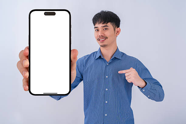 istock Young businessman showing big smartphone with blank screen. High quality studio shot. Concept for technology, business, finance and advertising. 2208462561