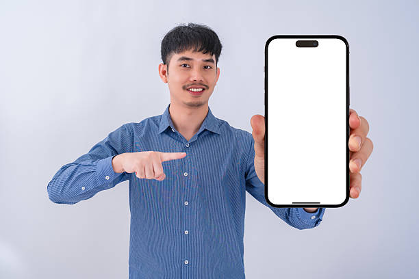 istock Young businessman showing big smartphone with blank screen. High quality studio shot. Concept for technology, business, finance and advertising. 2208462564