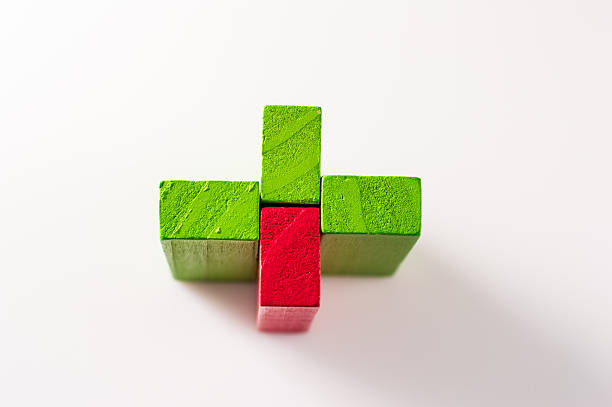 Wooden children's blocks are scattered on a light surface in a chaotic order. Colorful cubes create a bright and attractive scene. Educational wooden elements support the development of fine motor skills.