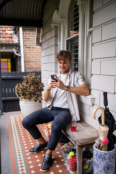 istock Man Relaxing on Bench in Front of His House 2208467768