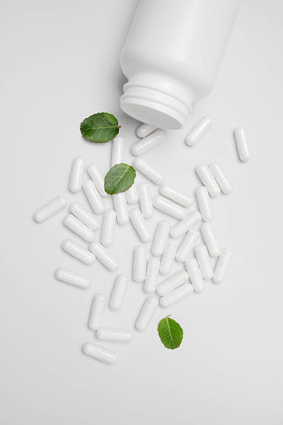 istock White capsules, pills, tablets spilled out of white jar on light background. Minimalistic concept of organic vitamins, dietary supplements, nutraceuticals. Homeopathy and herbal medicine 2208468611