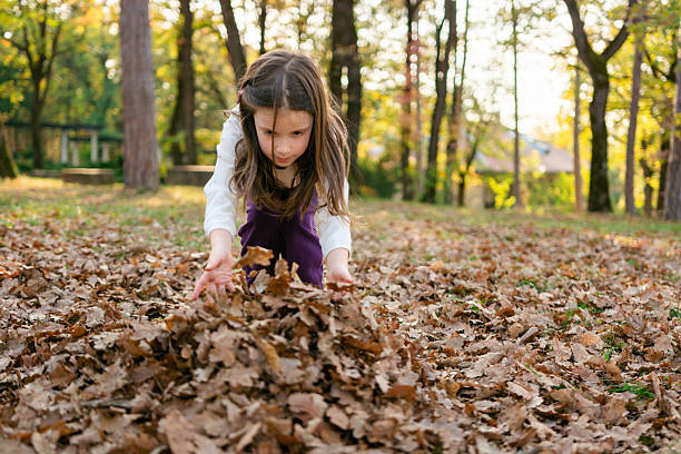 istock Girl playing whit autumn leaves 2208468767