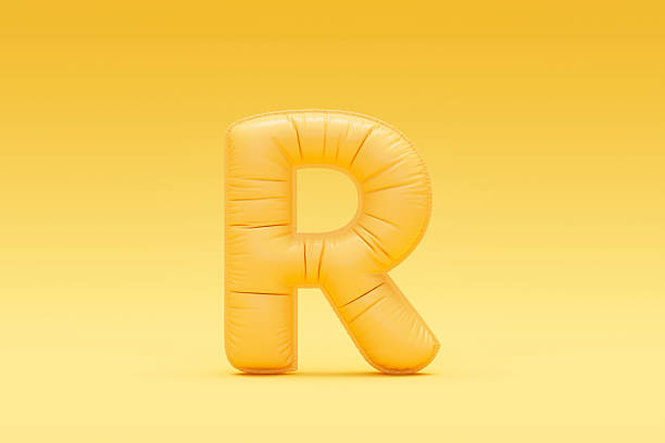 istock Letter R balloon yellow colored foil uppercase on yellow background 2208469340