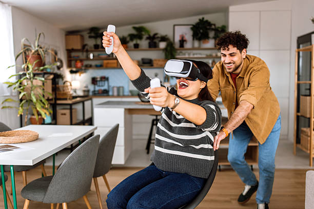 istock Young couple having fun with VR goggles at home. 2208469550