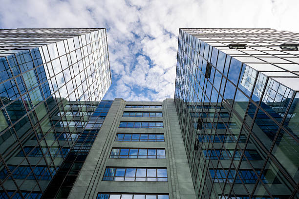 istock Contemporary Glass Office Towers Reaching Skyward Under Bright Blue Cloudy Sky 2208469841