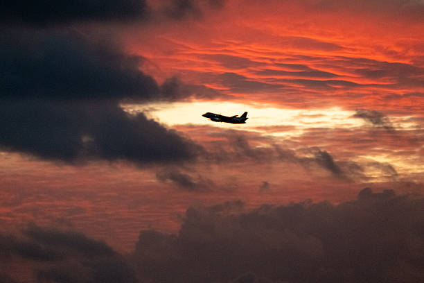 A Rex Airlines Saab 340B+ plane, registration VH-ZLC, taking off from Sydney Kingsford Smith Airport as flight ZL6477 to Griffith. This image was taken from Mill Stream Lookout, Botany Bay on a cloudy evening at sunset on 4 April 2025.