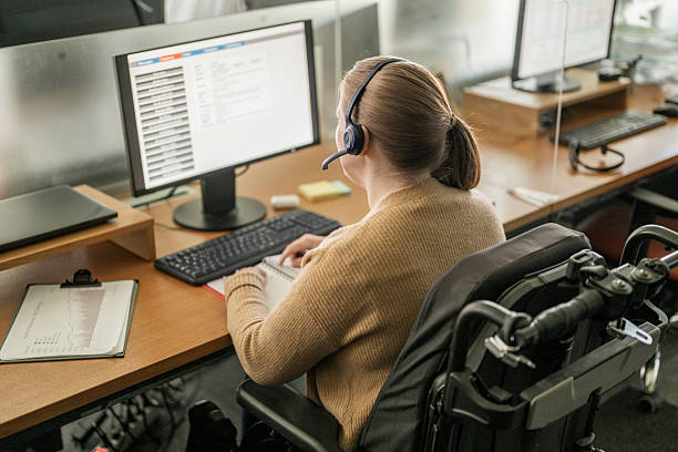 istock Young Disabled Businesswoman Working in Modern Office with Headset and Computer 2208470260