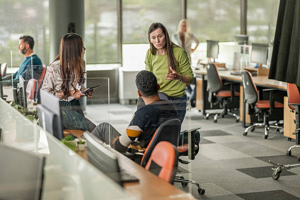 istock Diverse Business Team Collaborating in Modern Open Office Space with Natural Light 2208470333