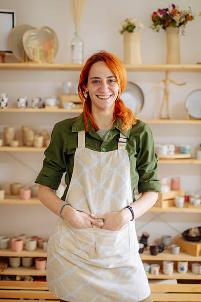 istock Red-haired artist posing in her ceramics studio 2208471445