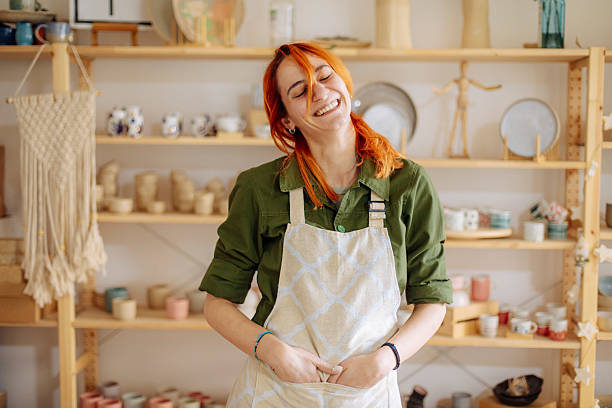 istock Red-haired artist posing in her ceramics studio 2208471468