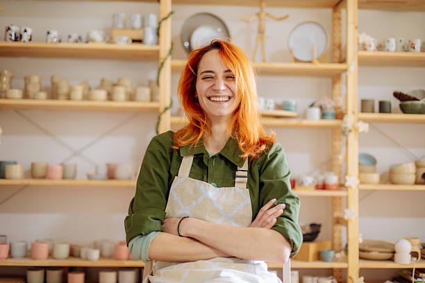 istock Red-haired artist posing in her ceramics studio 2208471485
