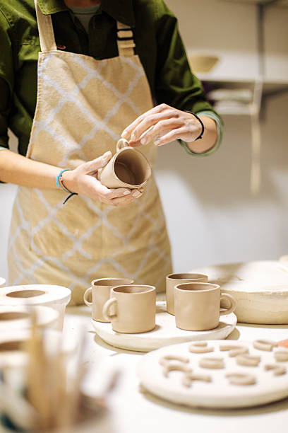 Female Artist Removing Fresh Clay from Mold in Studio