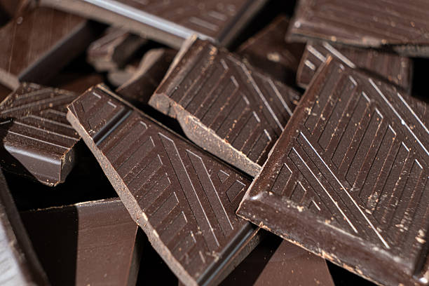 istock Delicious dark chocolate segments, rich black chocolate texture 2208472670