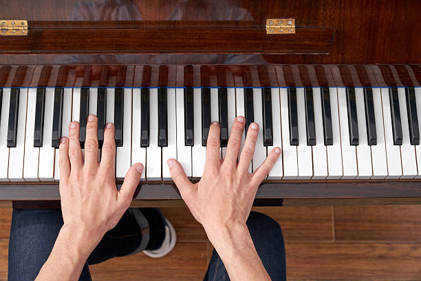 istock Musician playing a classical melody on a wooden piano 2208472708