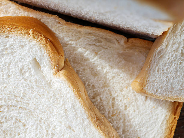 istock Close-up of freshly sliced soft and fragrant bread with white bread,brown bread crust macro 2208475533